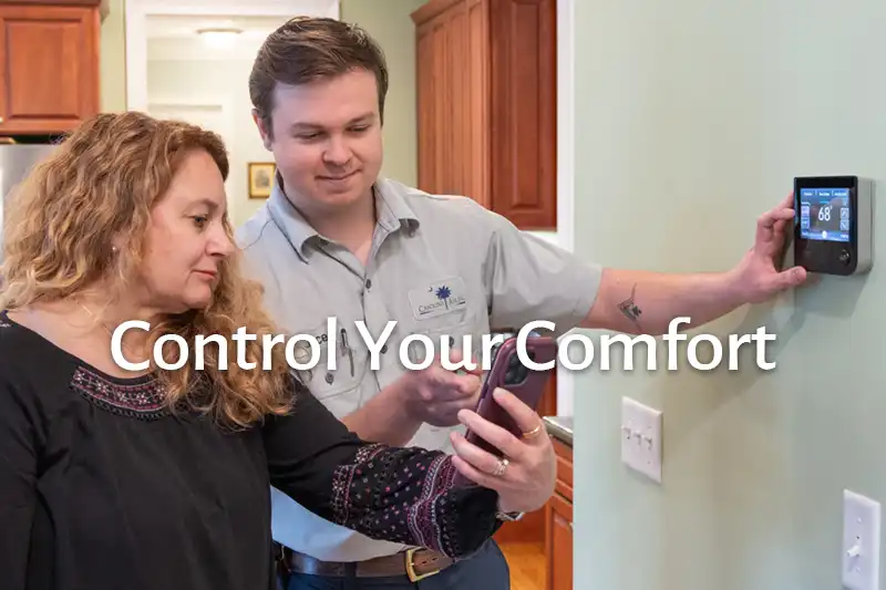 Carolina Air Technician assisting a homeowner with thermostat.